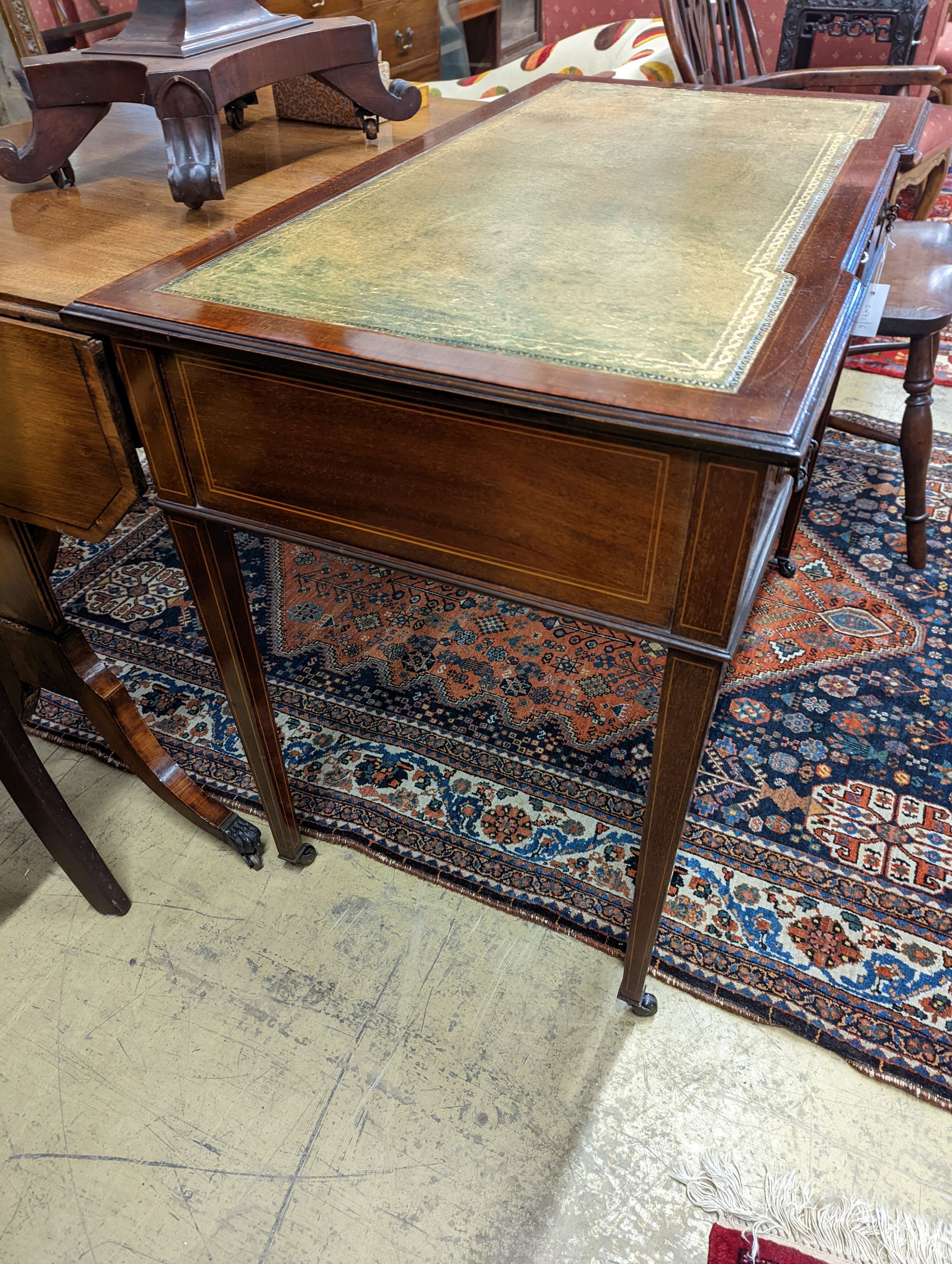 An Edwardian satinwood banded mahogany three drawer writing table, width 99cm, depth 53cm, height 75cm